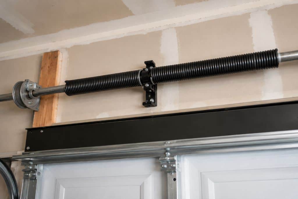 Close-up of a residential garage door torsion spring mounted above the garage door in Canoga Park.